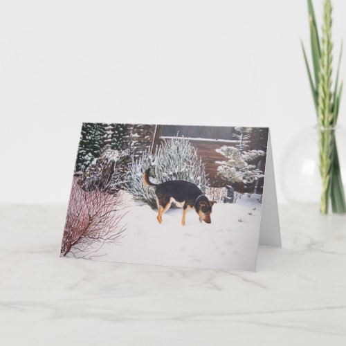 Winter snow scene with cute black dog at christmas holiday card