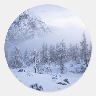 Winter wonderland, fog, spruce forest and mountain classic round sticker