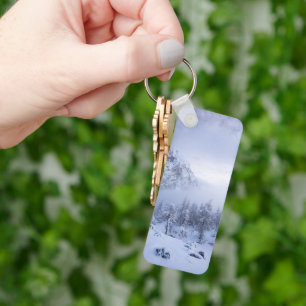 Winter wonderland, fog, spruce forest and mountain keychain