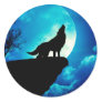 Wolf in silhouette howling to the full moon classic round sticker