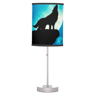 Wolf in silhouette howling to the full moon table lamp