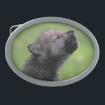 Wolf Pup Howling Oval Belt Buckle<br><div class="desc">Adorable black wolf pup howling in the grass.</div>