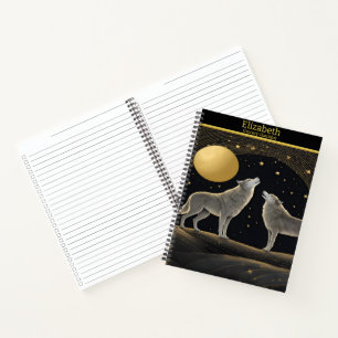 Wolves serenely howl at a radiant golden moon notebook
