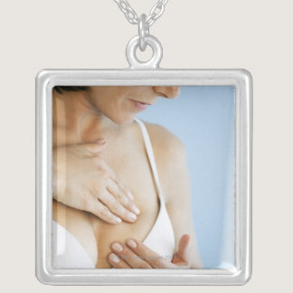Woman doing breast self exam 2 silver plated necklace