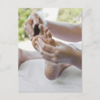 Woman getting foot massage with hot stone