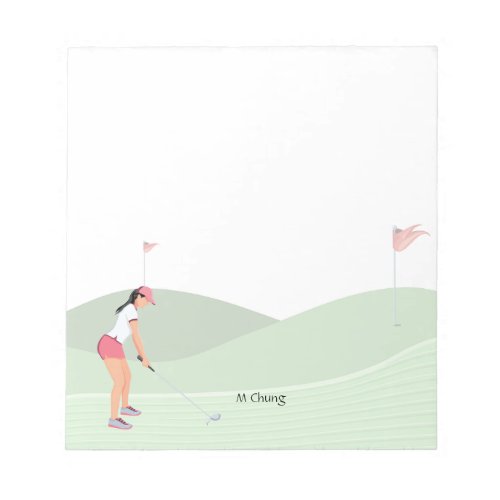 Woman golfer is golfing on the course  notepad