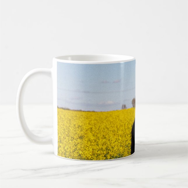 Woman in black coat standing on green grass field  coffee mug (Left)