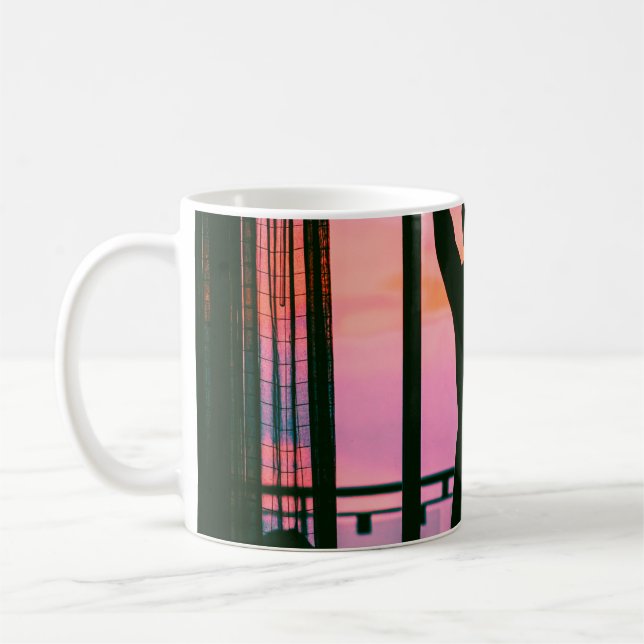 Woman in black tank top and pants standing on blac coffee mug (Left)