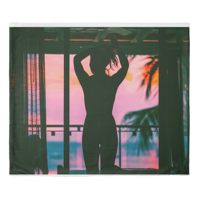 Woman in black tank top and pants standing on blac duvet cover (Front)