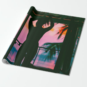 Woman in black tank top and pants standing on blac wrapping paper