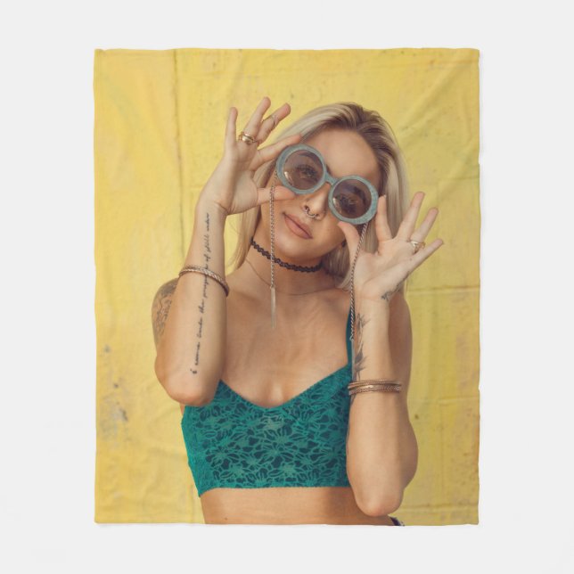 Woman in blue bralette holding sunglasses putting  fleece blanket (Front)