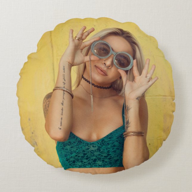 Woman in blue bralette holding sunglasses putting  round pillow (Front)