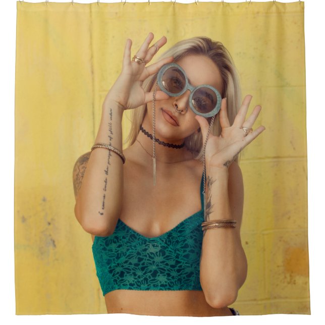 Woman in blue bralette holding sunglasses putting  shower curtain (Front)
