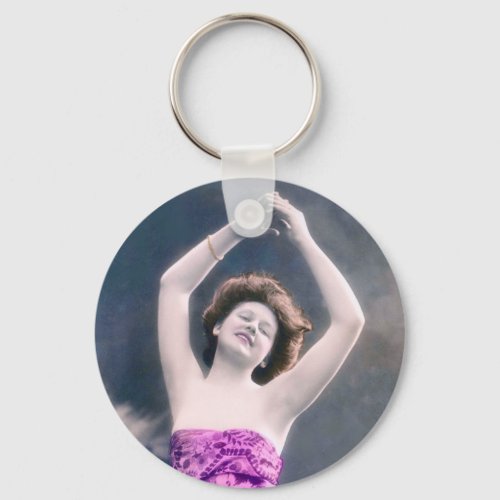 woman in purple sarong  arms raised as if dancing keychain