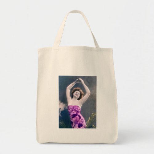 woman in purple sarong  arms raised as if dancing tote bag