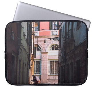 WOMAN IN WHITE SHIRT AND BLACK PANTS WALKING ON SI LAPTOP SLEEVE