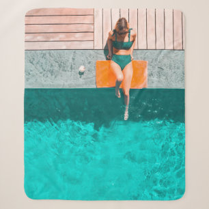 Woman lying beside swimming pool in the morning sherpa blanket