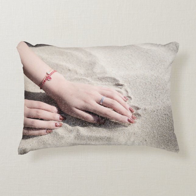 Woman lying on white sand accent pillow (Front)