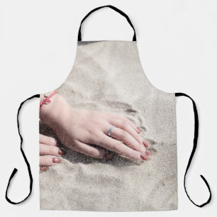 Woman lying on white sand apron