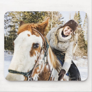 Woman on horse outdoors during winter mouse pad