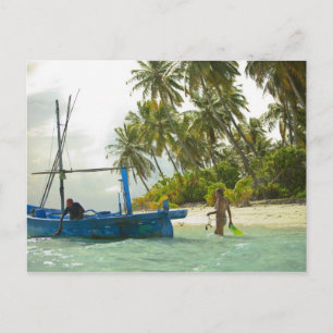 Woman on small traditional fishing boat, postcard
