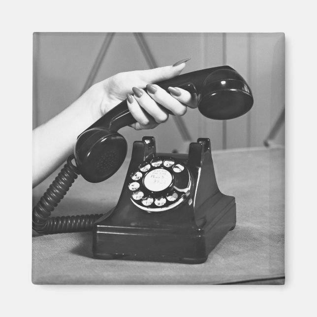 Woman picking up phone close up of hand magnet (Front)