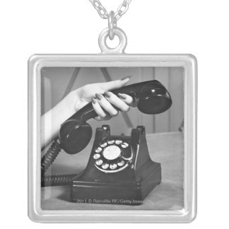 Woman picking up phone close up of hand silver plated necklace