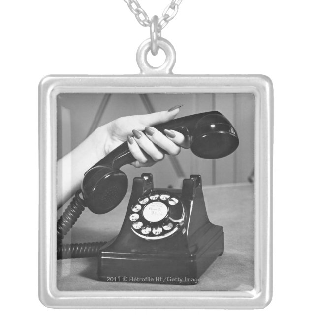 Woman picking up phone close up of hand silver plated necklace (Front)