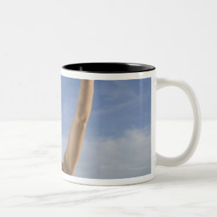 Woman playing volleyball on beach Two-Tone coffee mug