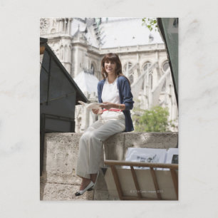 Woman reading a book at a book stall, Notre Dame Postcard