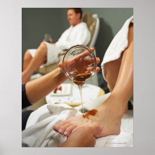 Woman receiving foot massage with oil poster
