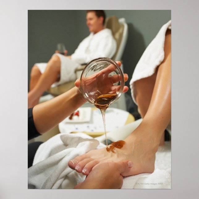 Woman receiving foot massage with oil poster (Front)