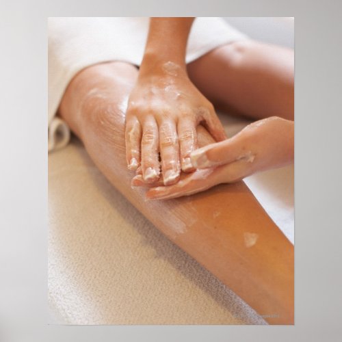 Woman receiving leg massage with lotion poster