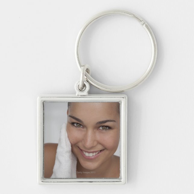Woman scrubbing her face with cloth keychain (Front)