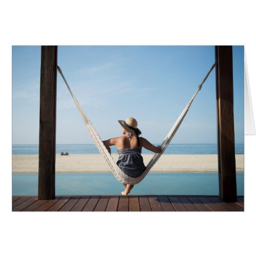 Woman Sitting On A Hammock At A Small Hotel