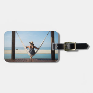 Woman Sitting On A Hammock At A Small Hotel Luggage Tag