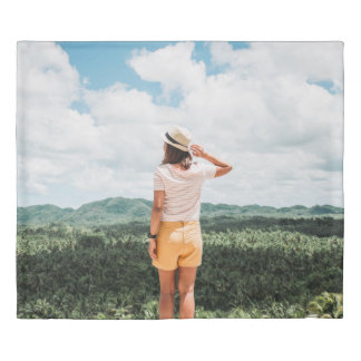 Woman standing near trees duvet cover
