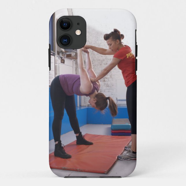 Woman stretching with trainer in gym Case-Mate iPhone case (Back)