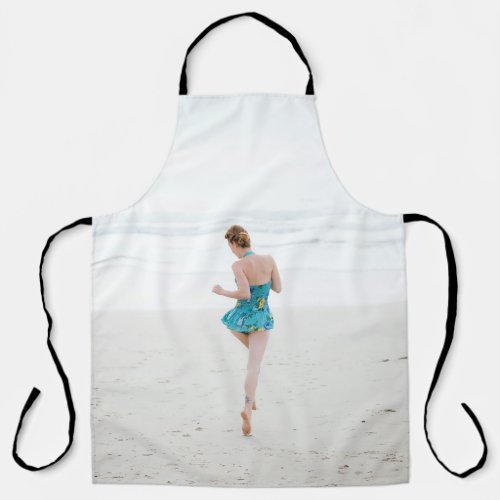 Woman walking on shore near beach apron