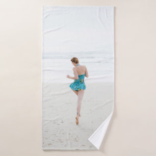 Woman walking on shore near beach bath towel