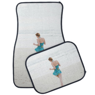 Woman walking on shore near beach car floor mat