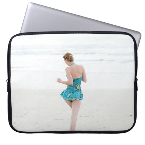Woman walking on shore near beach laptop sleeve