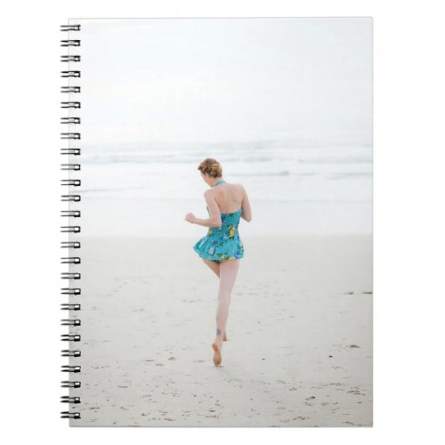 Woman walking on shore near beach notebook
