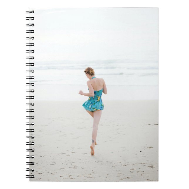 Woman walking on shore near beach notebook (Front)