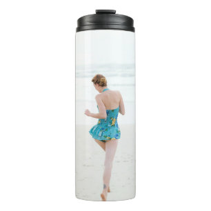 Woman walking on shore near beach thermal tumbler