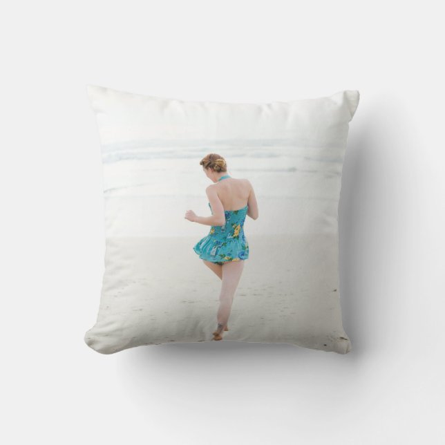 Woman walking on shore near beach throw pillow (Front)