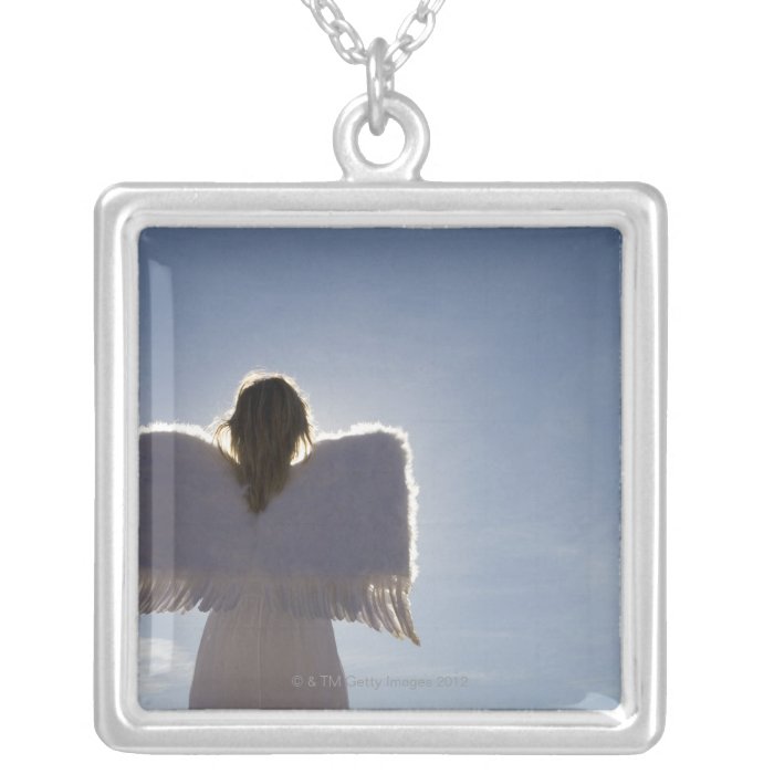 Woman wearing angel wings, rear view, three custom necklace