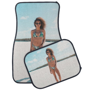 Woman wearing bikini standing on sand car floor mat