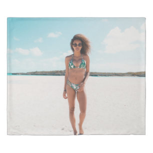 Woman wearing bikini standing on sand duvet cover