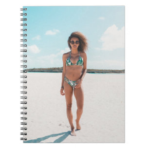 Woman wearing bikini standing on sand notebook